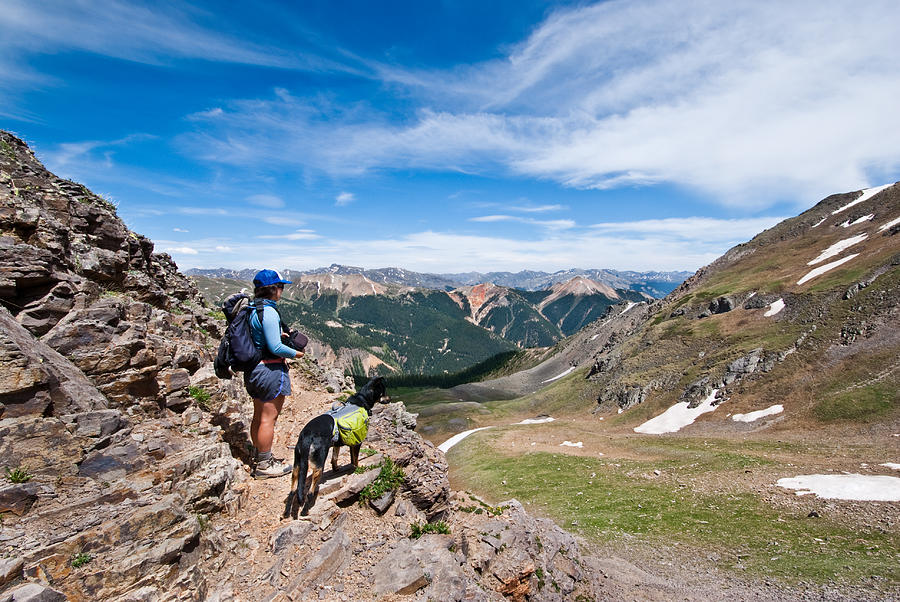 Hiker and Dog Looking at the View Photograph by JeffGoulden