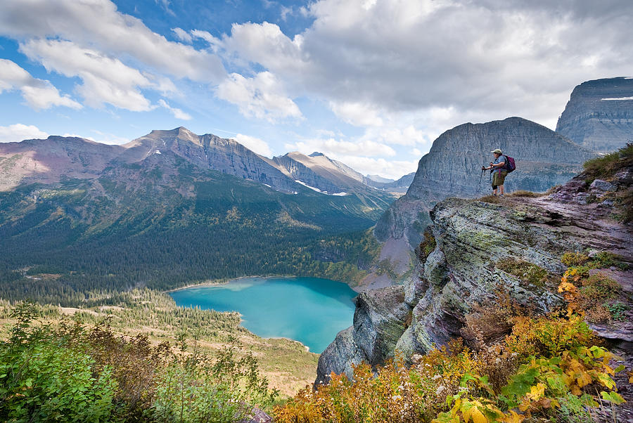 Hiker Looking Down on Lower Grinnell Lake Photograph by JeffGoulden