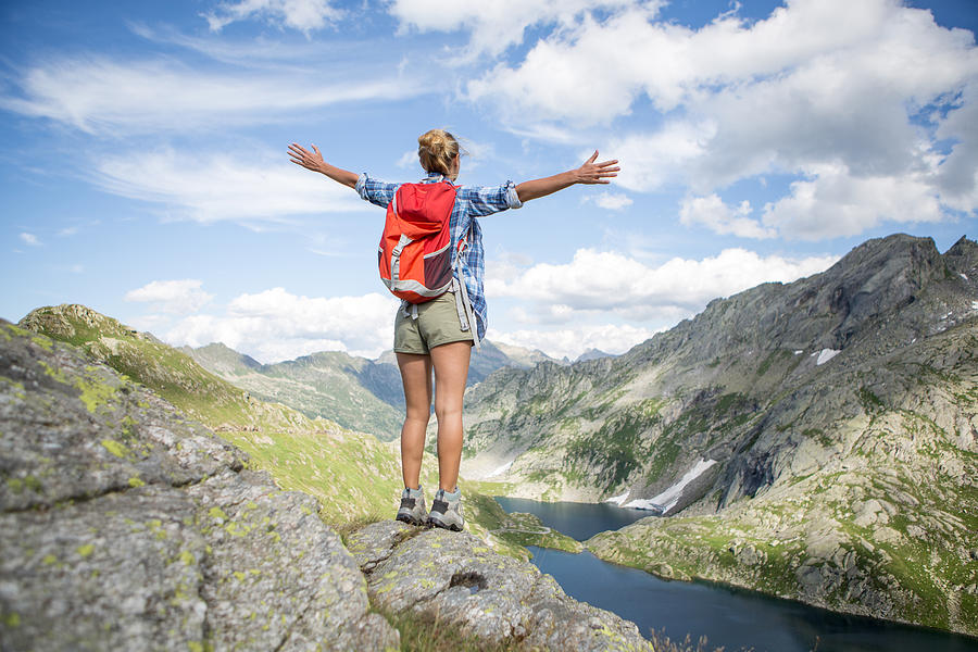Hiker reaches mountain top-Success Photograph by Swissmediavision