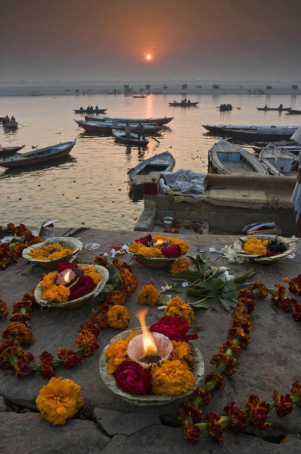 Hindu pilgrims come to Varanasi on the River Ganges to make offerings at the ghats, and swim in the sacred waters. Photograph by Mint Images - Art Wolfe
