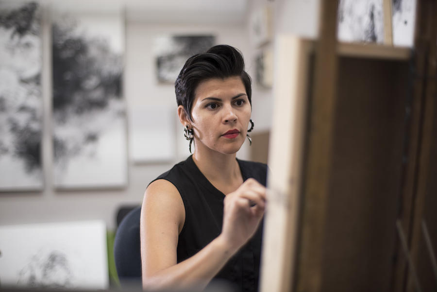 Hispanic artist working in her studio Photograph by Scott Zdon