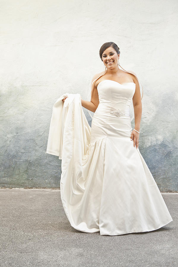 Hispanic bride in wedding dress Photograph by Blend Images/Sollina Images