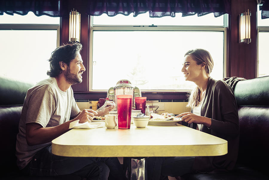 Hispanic couple eating breakfast in diner Photograph by Jacobs Stock Photography Ltd