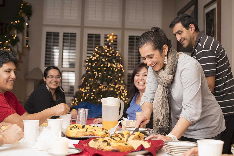 Hispanic family enjoying traditional Christmas dessert Photograph by Sollina Images