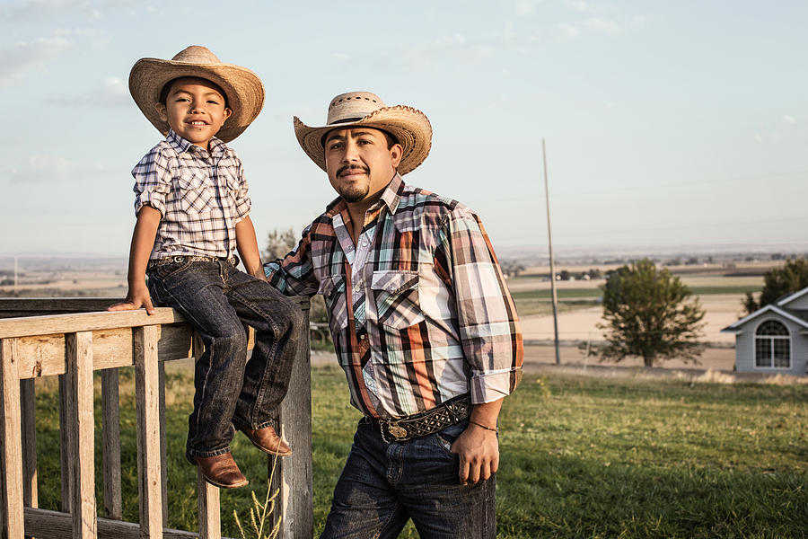 Hispanic father and son wearing cowboy hats outdoors Photograph by Hill Street Studios
