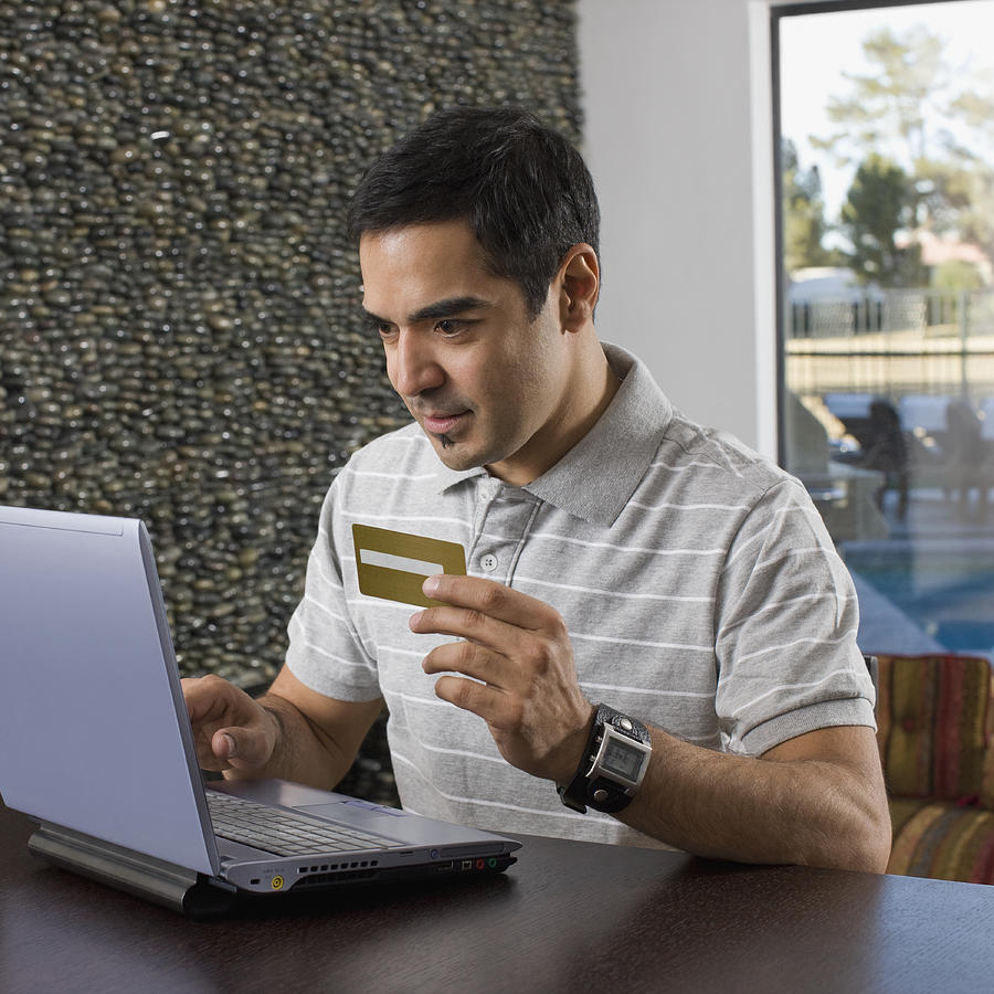 Hispanic man shopping online Photograph by PictureNet Corporation