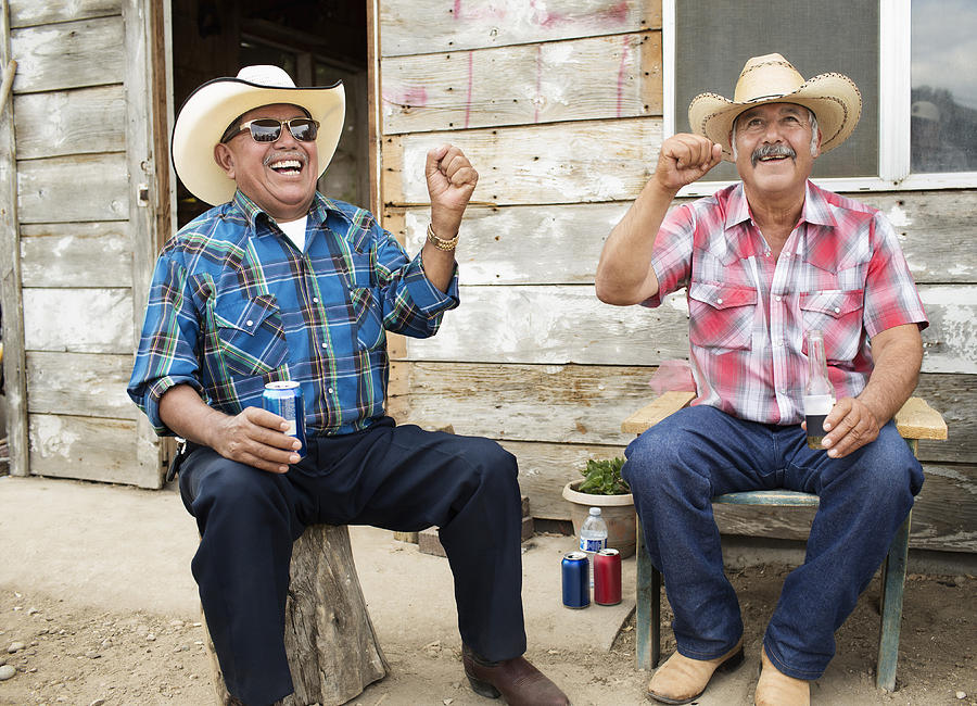 Hispanic men wearing cowboy hats cheering Photograph by Hill Street Studios