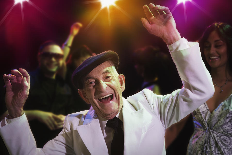 Hispanic senior man dancing in nightclub Photograph by Jose Luis Pelaez Inc