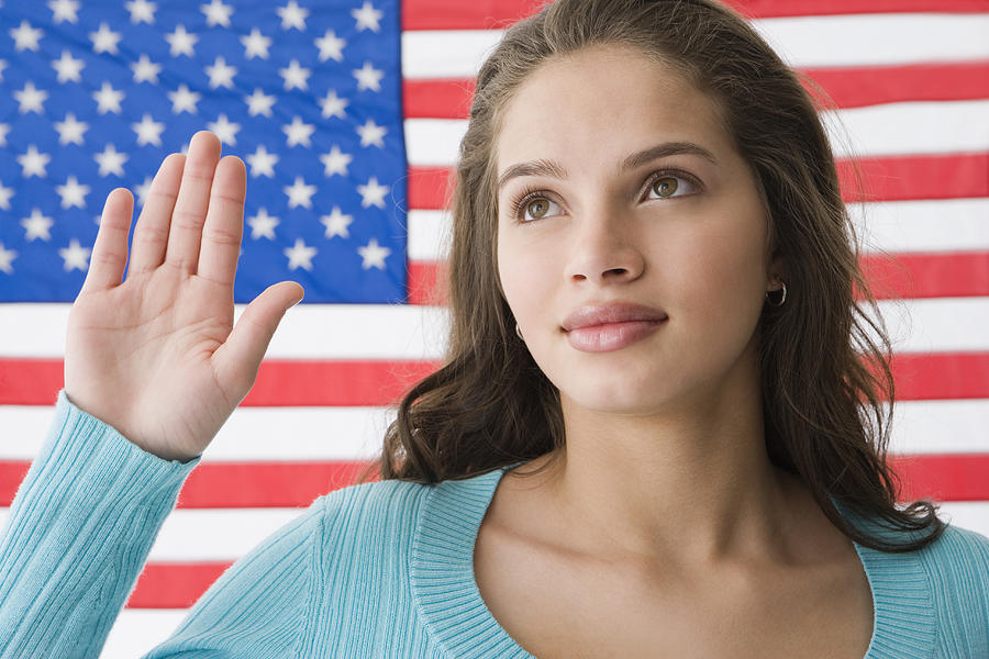 Hispanic teenaged girl in front of American flag Photograph by Jose Luis Pelaez Inc