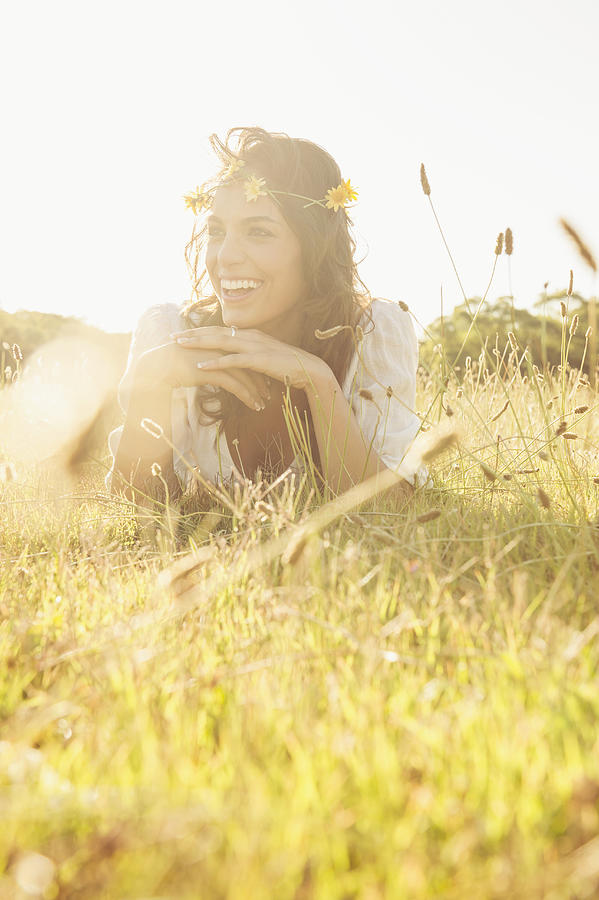 Hispanic woman wearing flower crown in grass Photograph by Jacobs Stock Photography Ltd