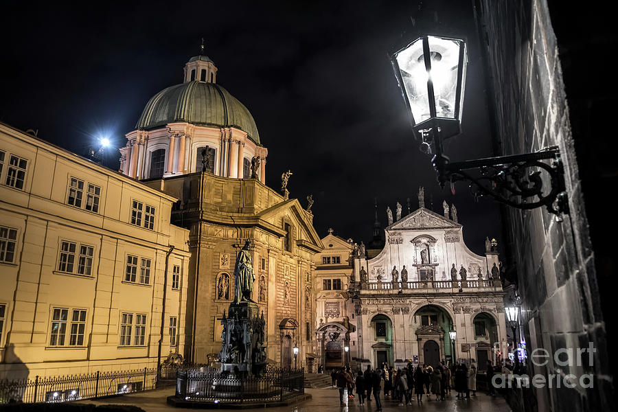 Historic Buildings Beneath The Tower Of Charles Bridge In The Night In Prague In The Czech Republic Photograph by Andreas Berthold