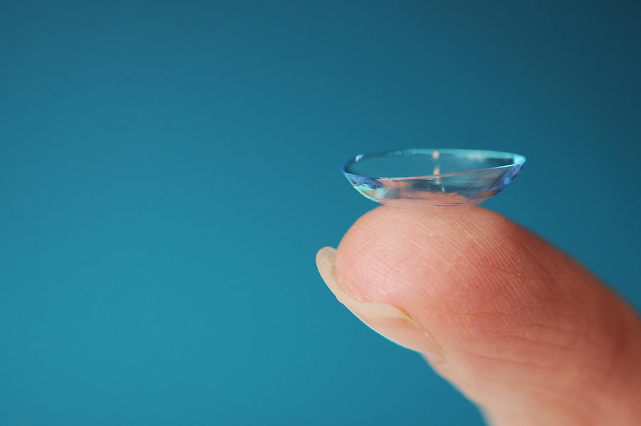 Holding a contact lens on finger tip Photograph by Jjpoole