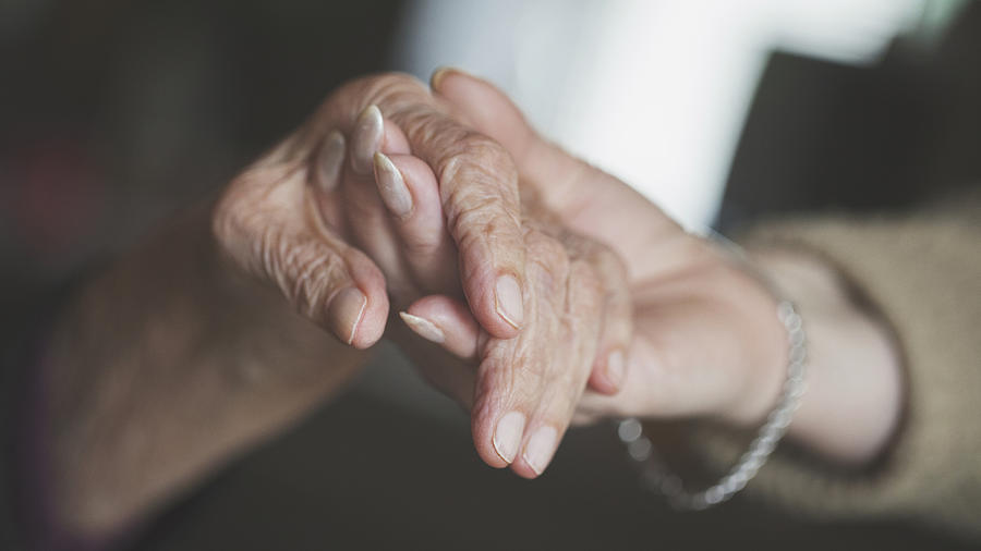 Holding hand of very old woman-home caregiver Photograph by Branimir76