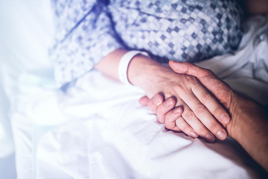 Holding Hands in Hospital Bed Photograph by RyanJLane