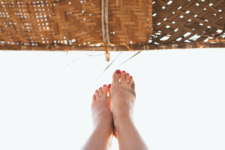 Holiday makers feet, Goa, India Photograph by Matilda Delves