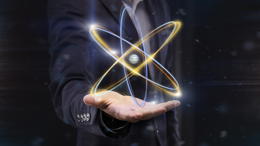 Hologram of atom on male hand, panorama Photograph by Prostock-Studio
