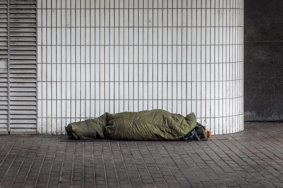 Homeless man sleeping outside Euston Station Photograph by Carstenbrandt