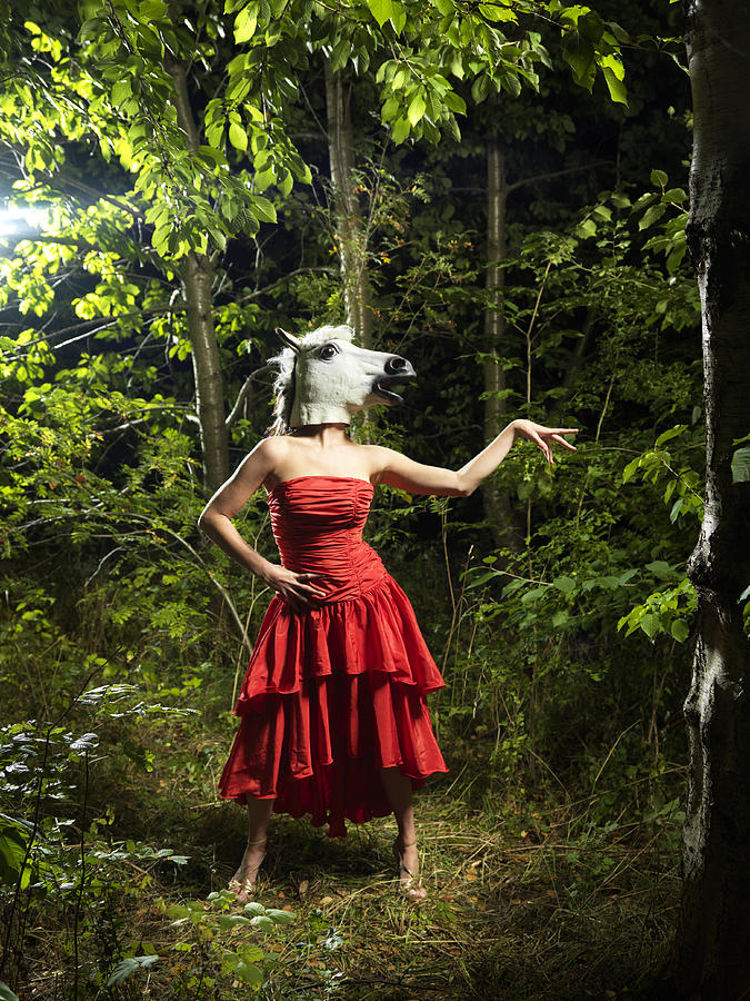 Horse woman standing in red dress in forest Photograph by Henrik Sorensen