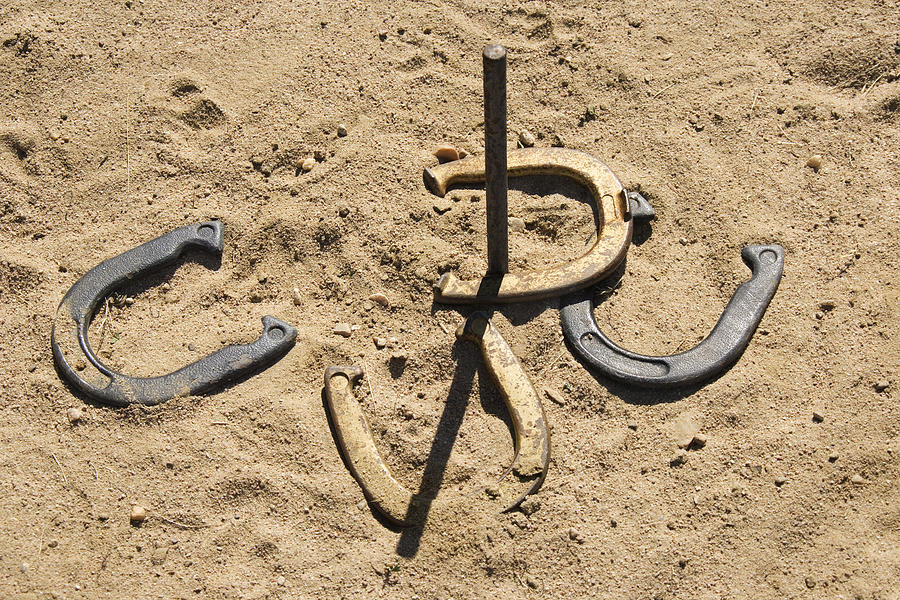 Horseshoes and stake Photograph by Jupiterimages