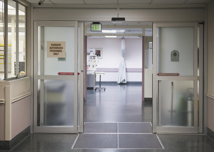 Hospital corridor with open doors Photograph by Andersen Ross