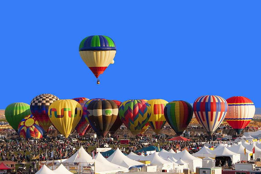 Hot air balloon floating above others at festival, Albuquerque, New Mexico, United States Photograph by Camilo Morales