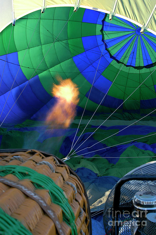 Hot air balloon getting filled with a blast of fiery hot air.  Photograph by Gunther Allen