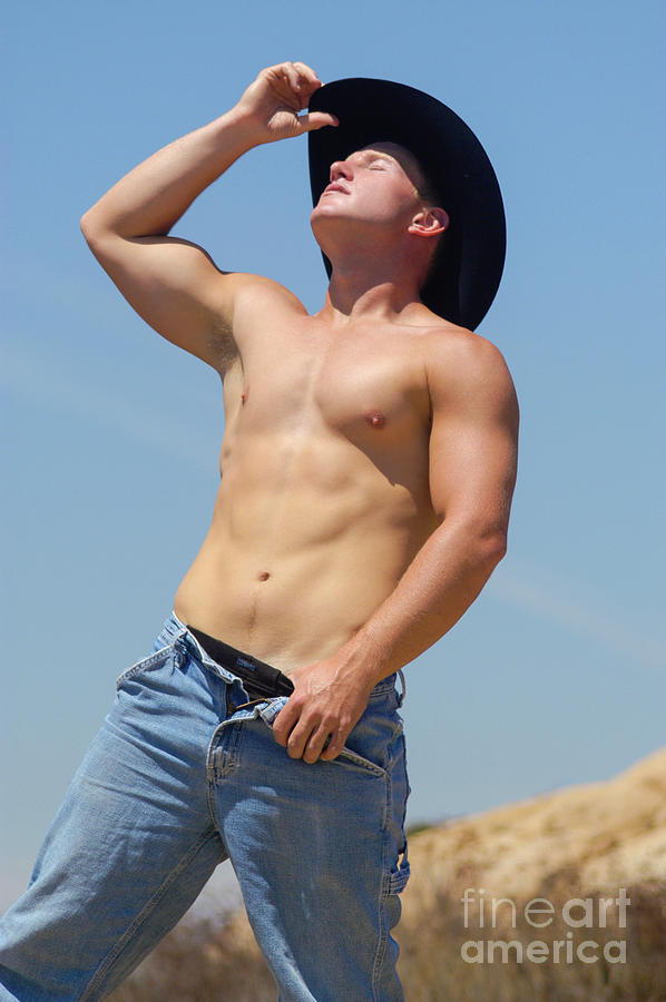 Hot blond haired cowboy is taking off his clothes Photograph by Gunther Allen