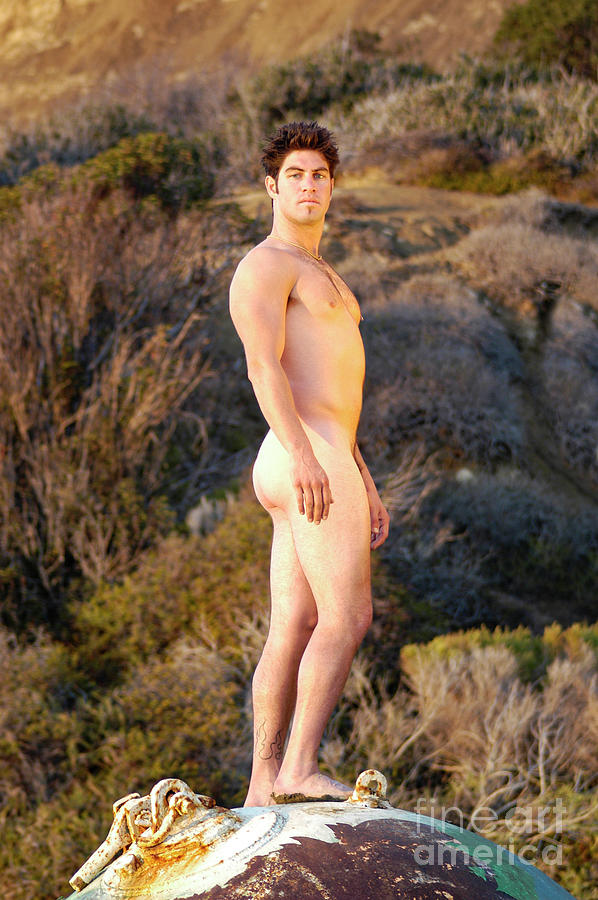 Hot looking athletic young man stand naked for a beach portrait.  Photograph by Gunther Allen