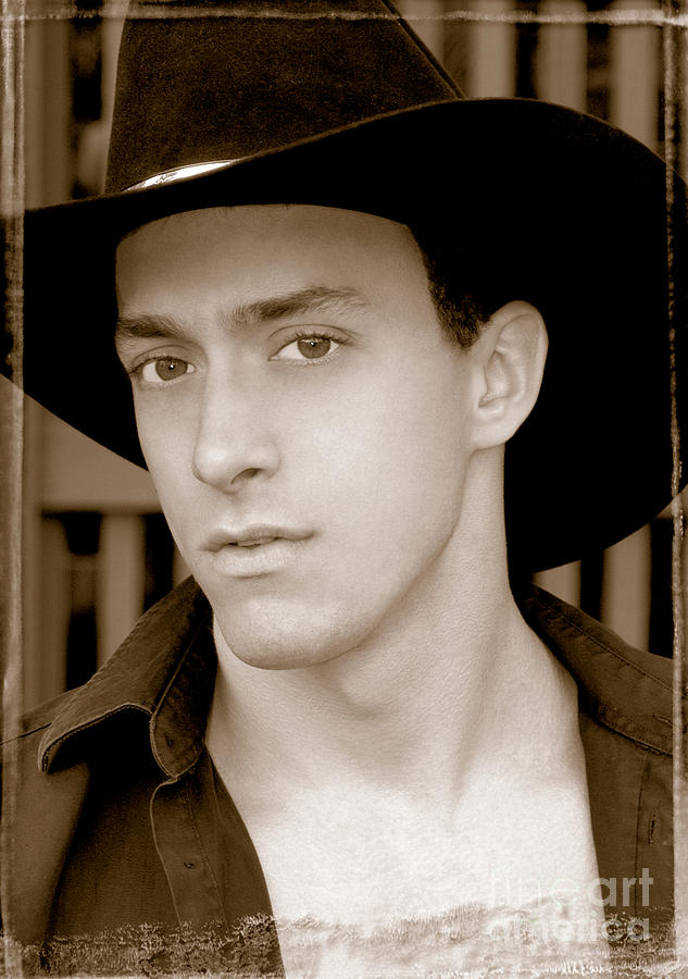 Hot looking cowboy in wearing his dress cowboy hat.  Photograph by Gunther Allen