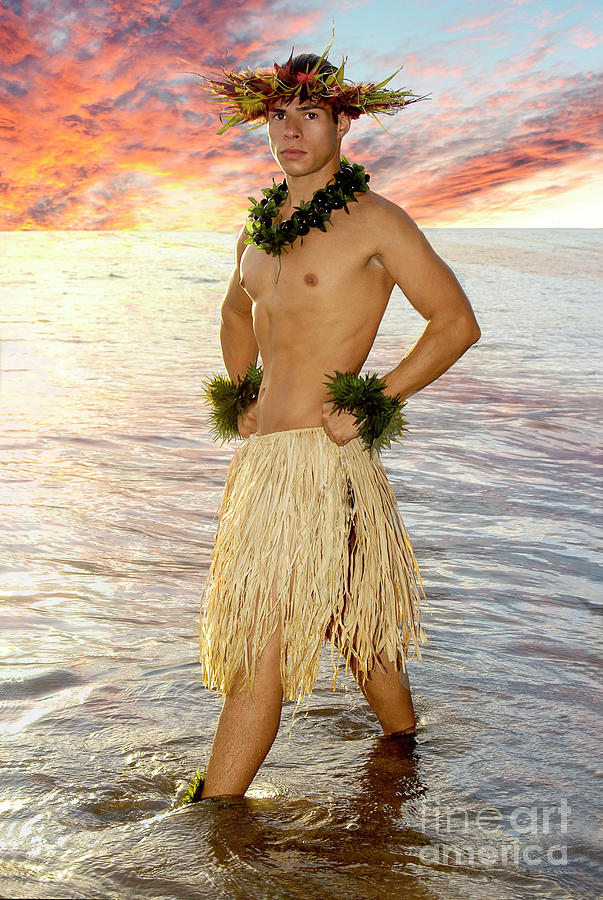 Hot male hula dancer poses at sunset in the water.  Photograph by Gunther Allen