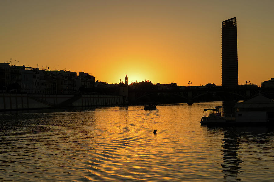 Hot Sevillian Silhouettes - Sunset Behind Capilla del Carmen on Guadalquivir River  Photograph by Georgia Mizuleva