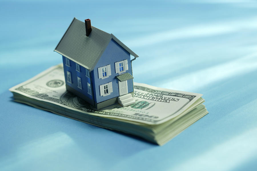 House on stack of money Photograph by Comstock Images