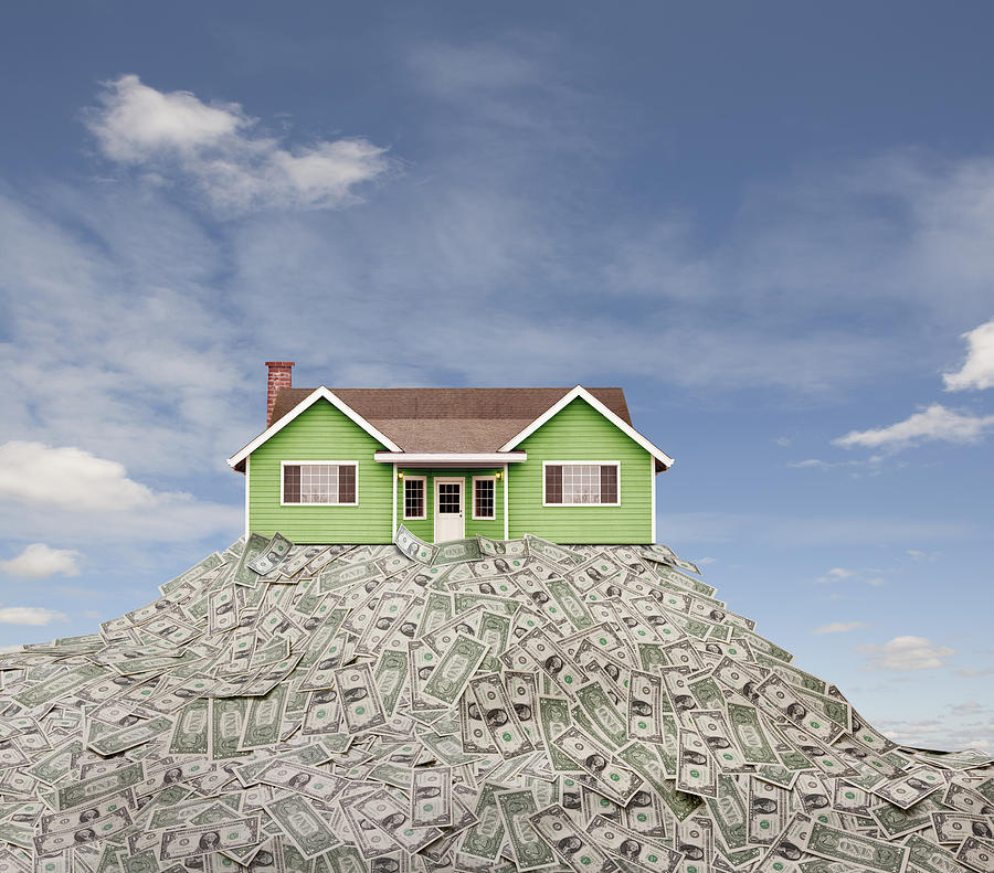 House sitting on pile of dollar bills Photograph by John M Lund Photography Inc