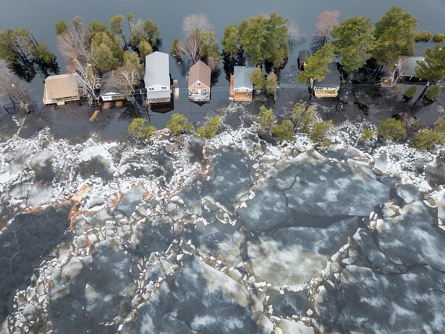 Huge chunks of ice propelled by wind and flood waters  threatens cottages on Grand Lake, New Brunswick, Canada Photograph by by Marc Guitard