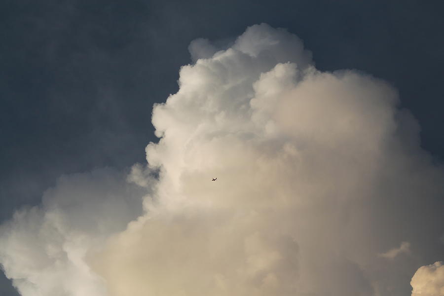 Huge cloud, tiny airplane Photograph by Jindra Noewi