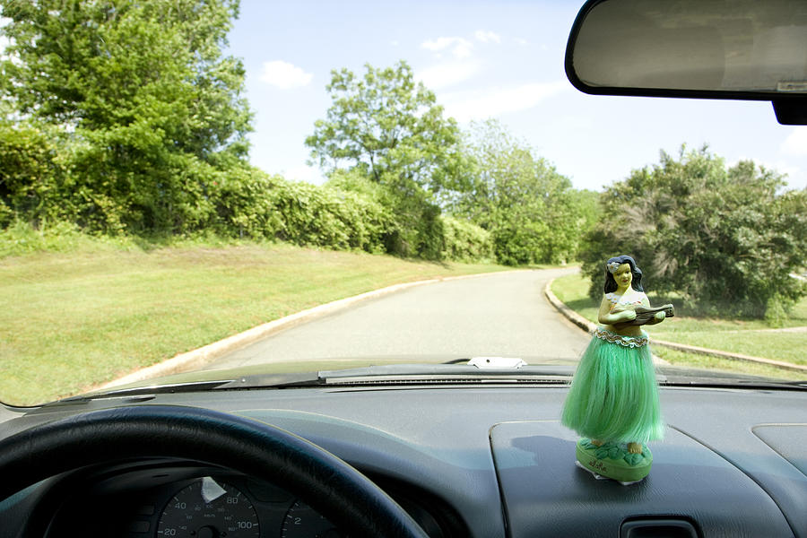 Hula girl on dashboard of car interior Photograph by Fotosearch