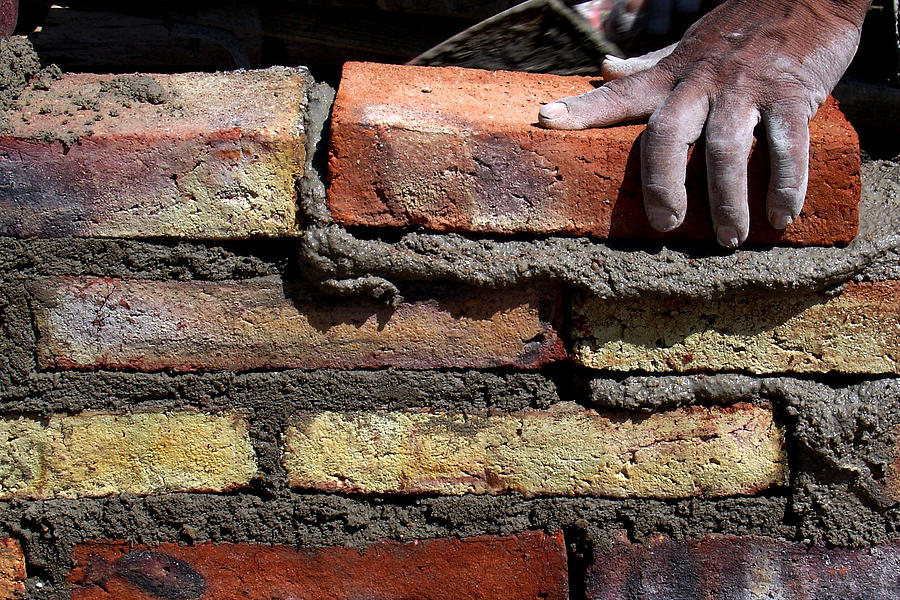 Human hand building brick wall Photograph by Memo Vasquez Human hand building brick wall Photograph by Memo Vasquez