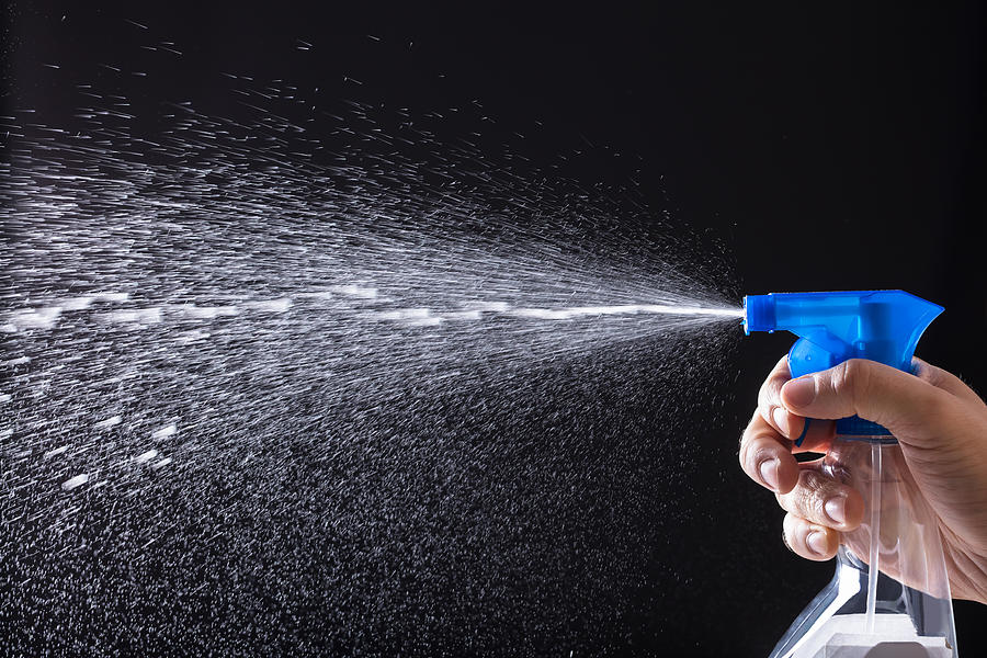 Human Hand Spraying Water With Spray Bottle Photograph by AndreyPopov