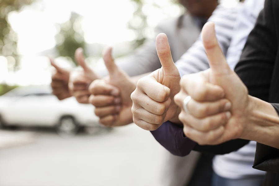 Human hands showing thumbs up sign Photograph by Maskot