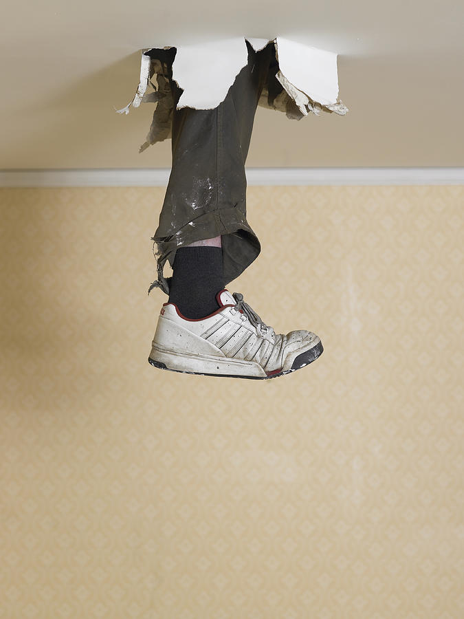Human leg dangling from hole in ceiling Photograph by Michael Blann