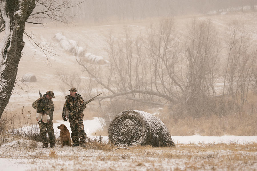 Hunters waterfowl hunting Near Hay Bales in Winter Photograph by Mitch Kezar / Design Pics