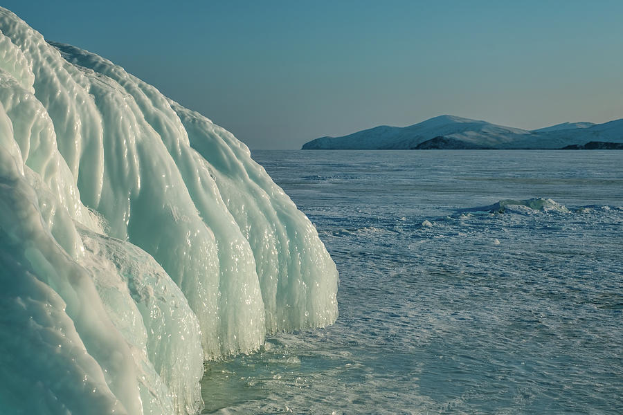 Ice and icicles on rocks on Lake Baikal Photograph by Mikhail Kokhanchikov