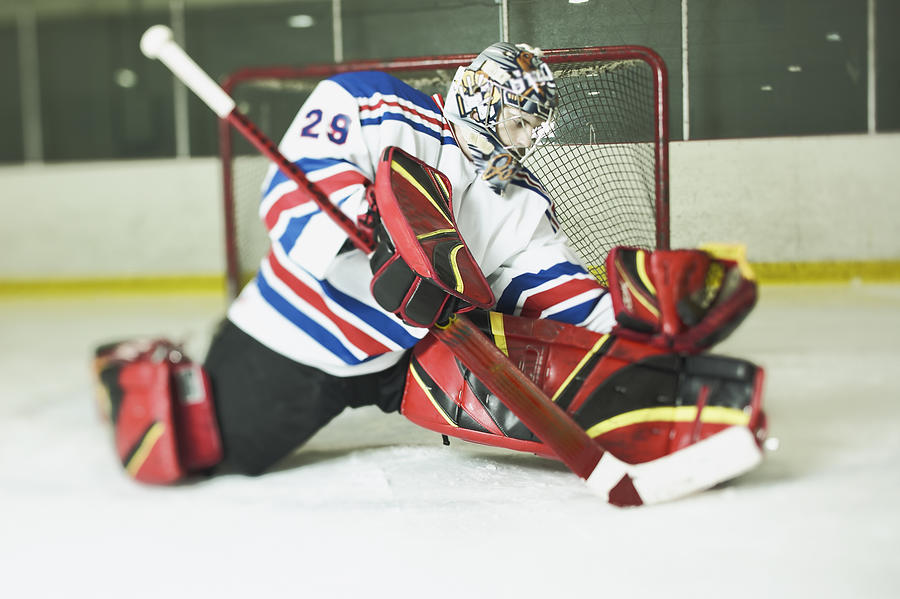 Ice hockey goalie in defensive pose Photograph by Jupiterimages