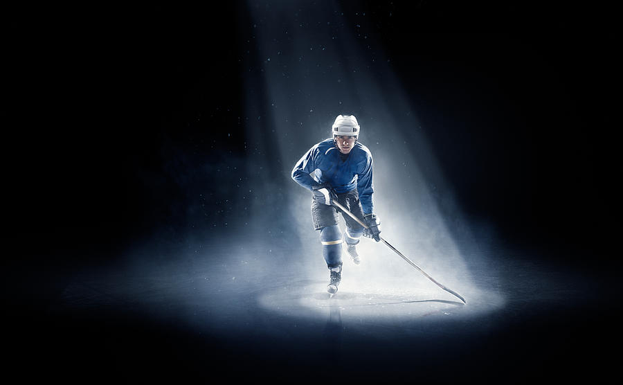 Ice hockey player is spotlight Photograph by Dmytro Aksonov
