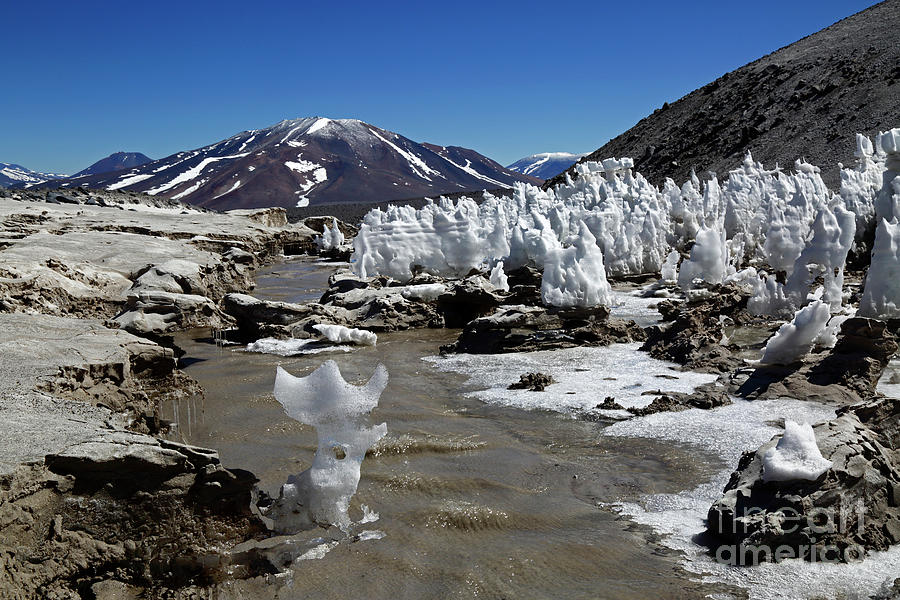 Ice sculpture in stream and Mulas Muertas volcano Chile Photograph by James Brunker