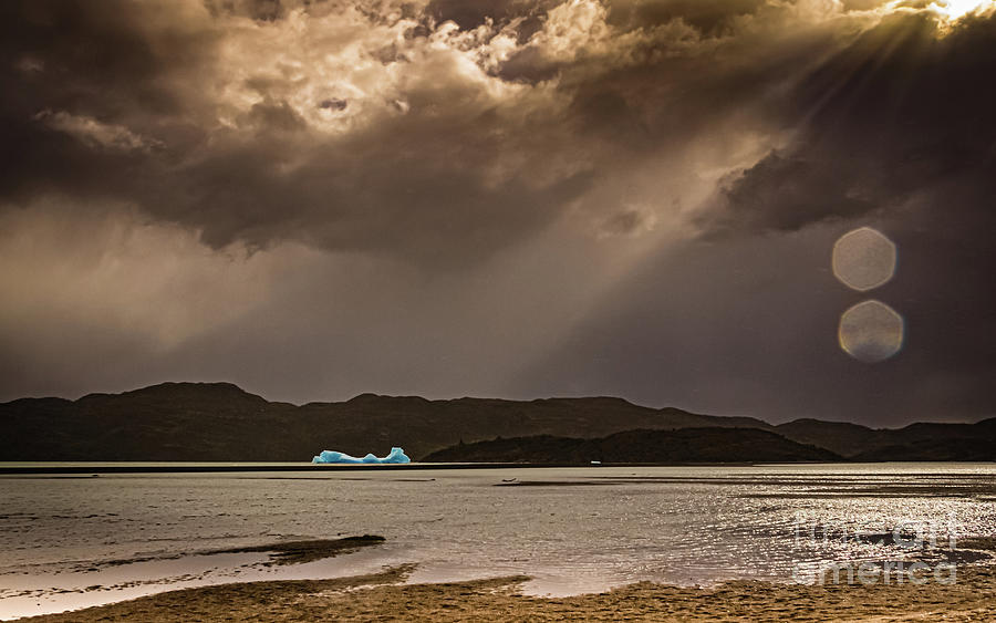 Iceberg lit by the sun on Lago Grey Photograph by Lyl Dil Creations