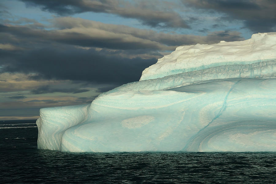 Iceberg with surrealistic blue swirls Photograph by Steve Estvanik