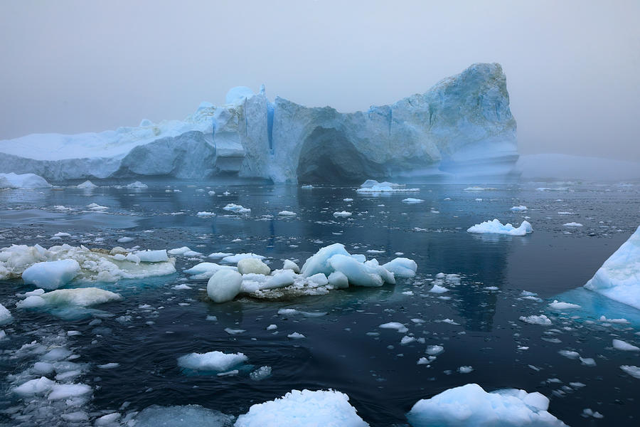 Icebergs floating in the sea on a foggy and cloudy day Photograph by Rainer Grosskopf