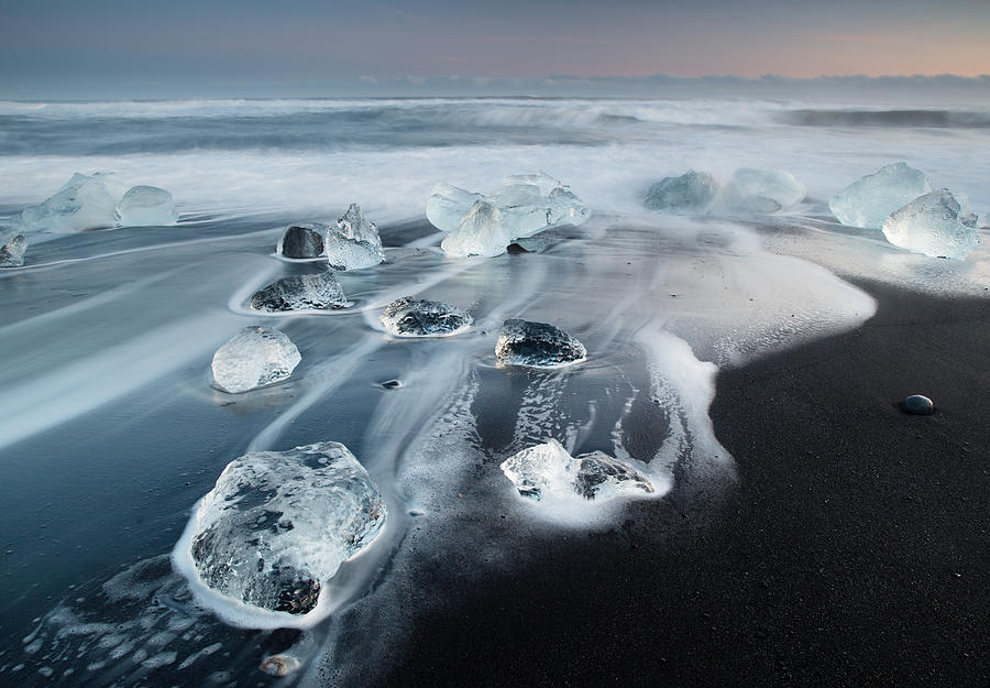 Icebergs on a beach at sunrise. Photograph by Alex Saberi