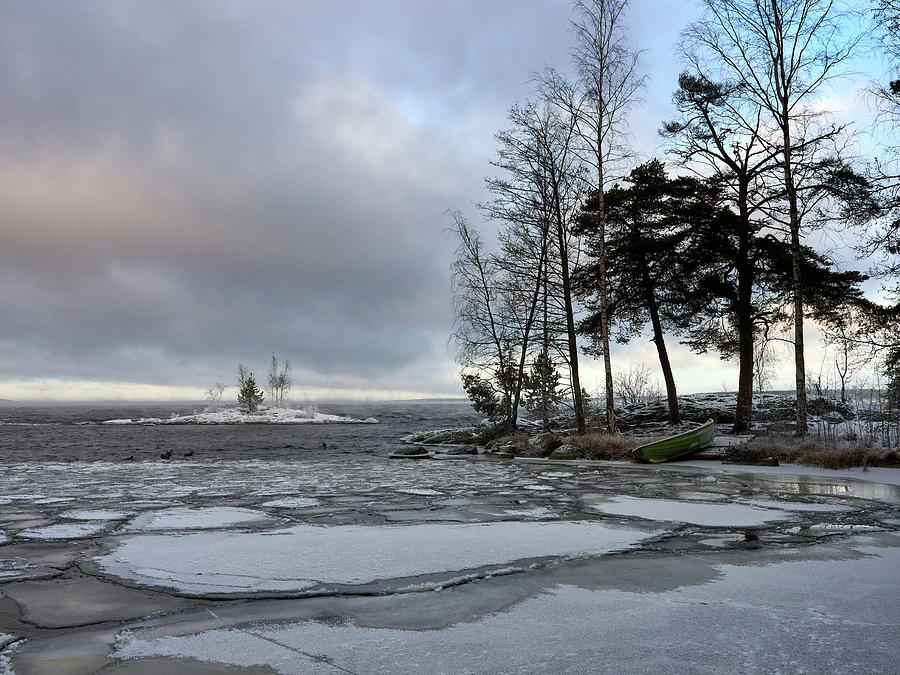 Iceplates ducks and a rowing boat at Nasijarvi Photograph by Jouko Lehto